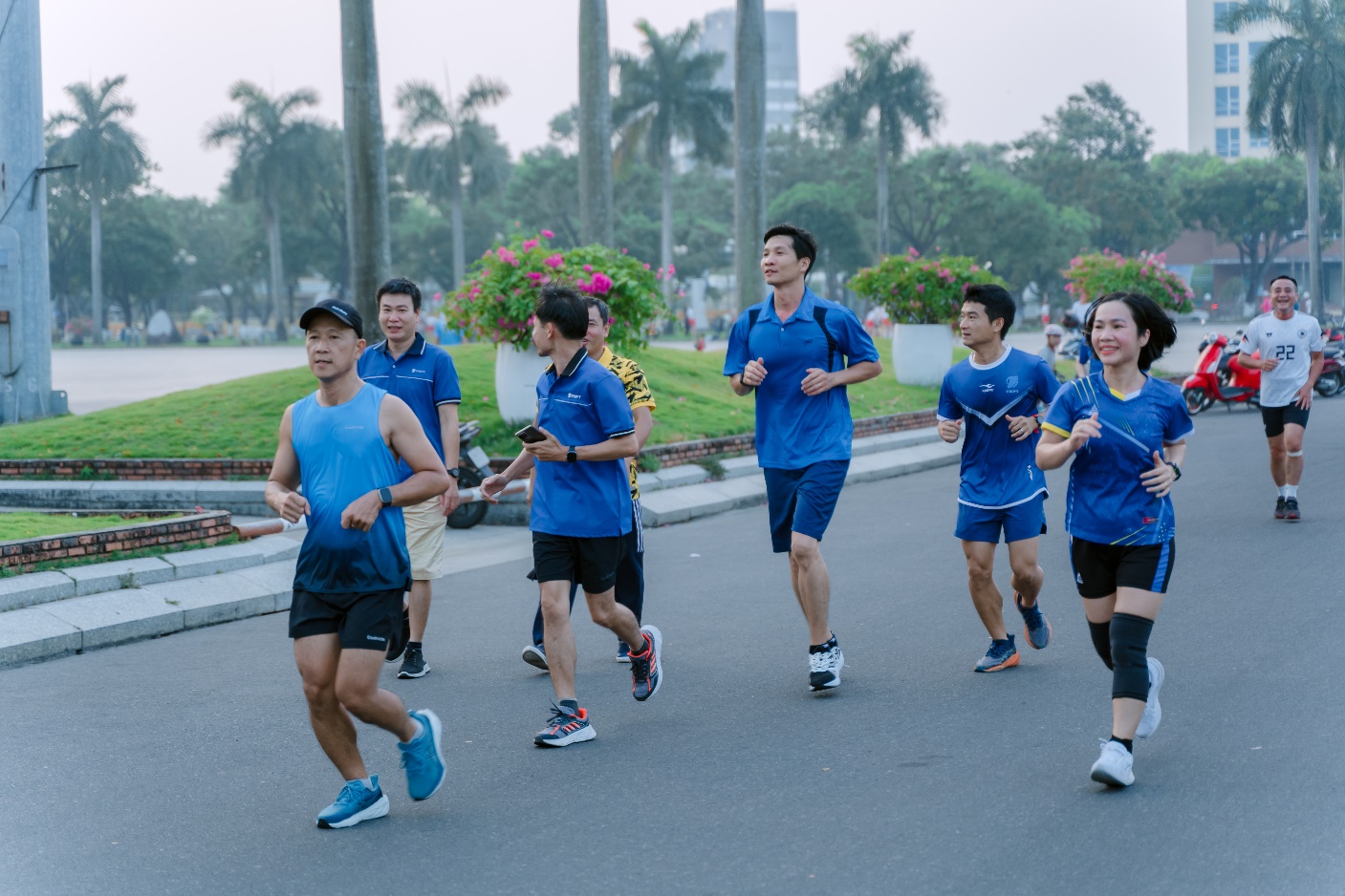 Description: A group of people running on a street
Description automatically generated