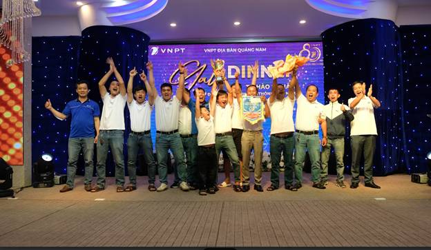 A group of people standing on a stage
Description automatically generated