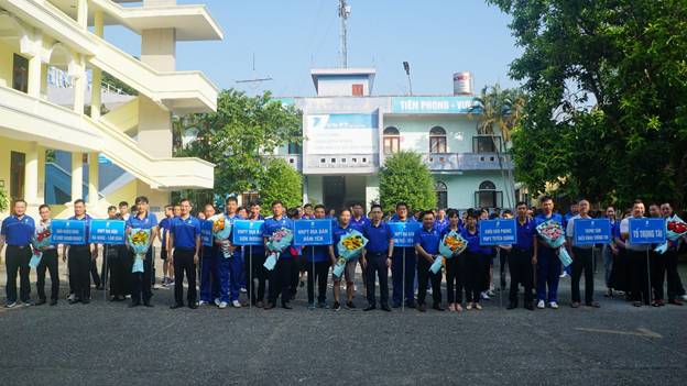 A group of people in blue shirts holding signs

AI-generated content may be incorrect.