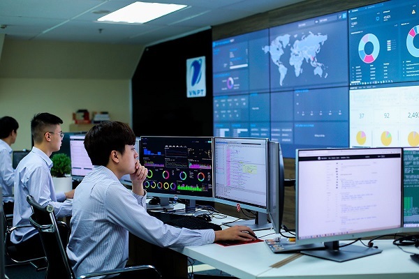 A group of people sitting at a desk with multiple monitors
AI-generated content may be incorrect.