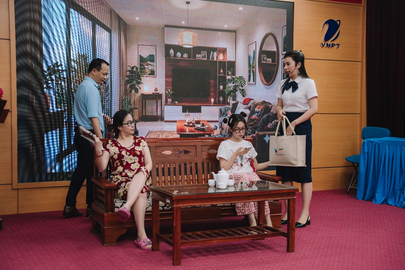 A group of women sitting on a bench in a room
Description automatically generated