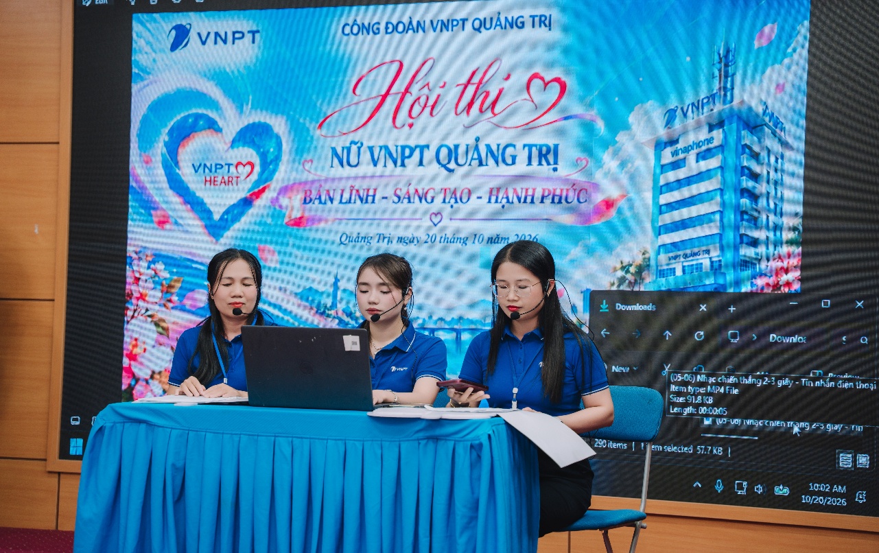A group of women sitting at a table with a computer
Description automatically generated