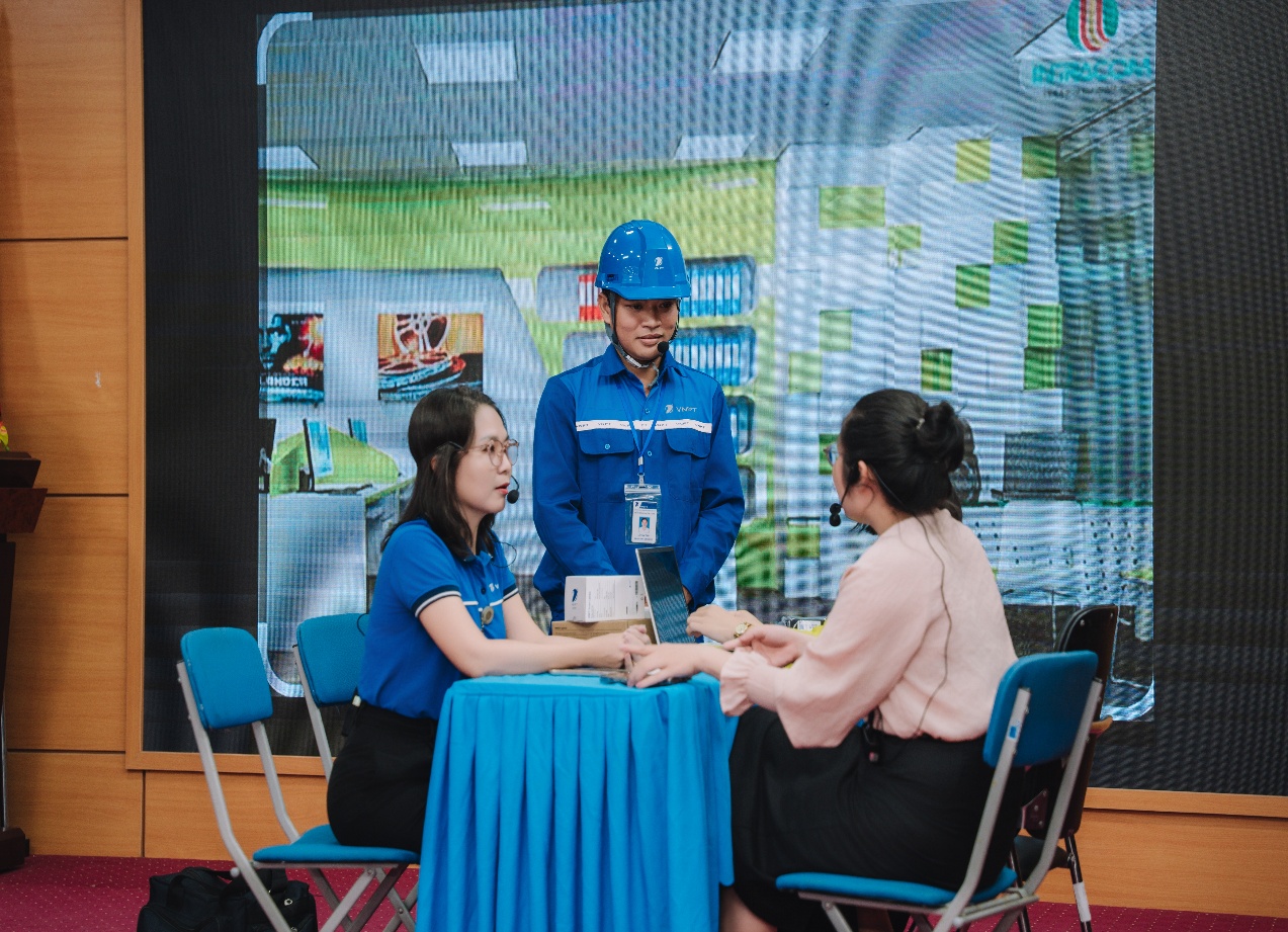 A person in a blue shirt and blue shirt talking to a group of women
Description automatically generated