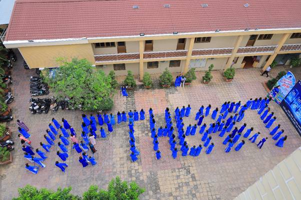 A group of people in blue dresses

Description automatically generated