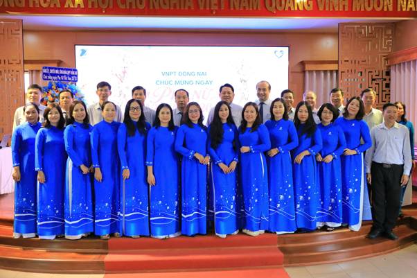 A group of people in blue dresses

Description automatically generated