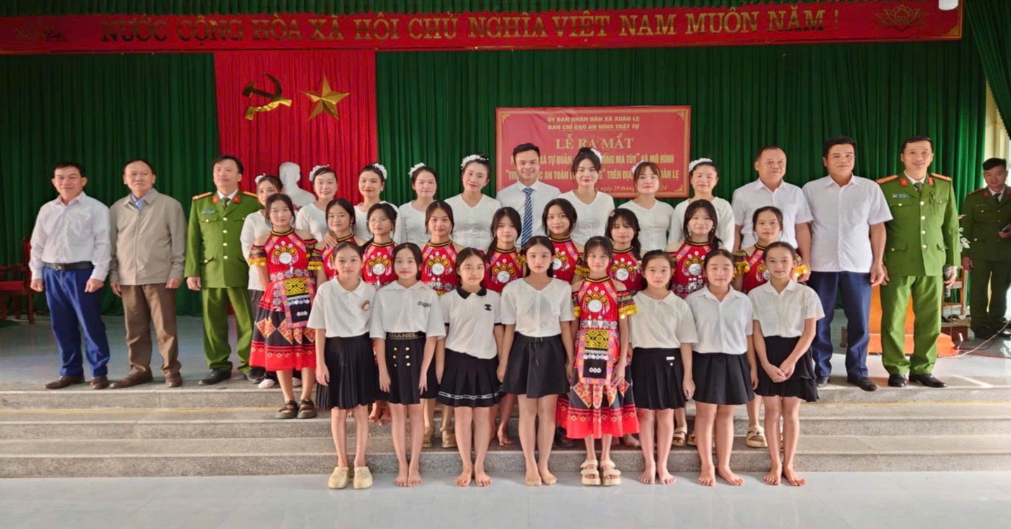A group of people posing for a photo
Description automatically generated