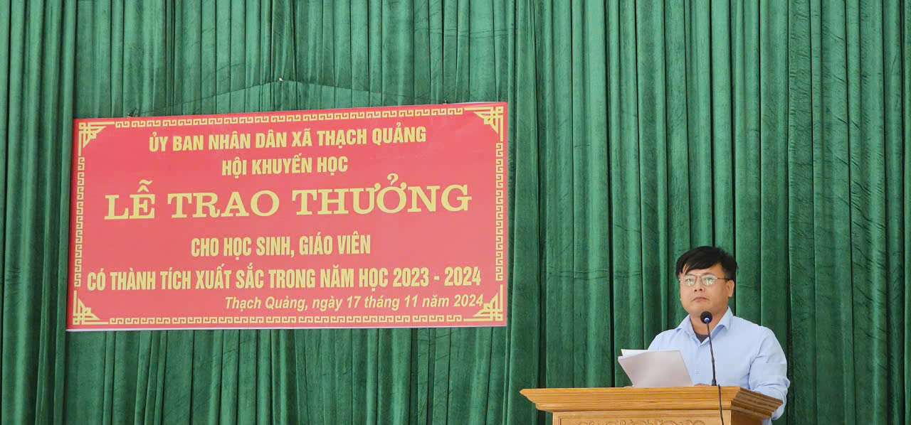 A person standing at a podium
Description automatically generated