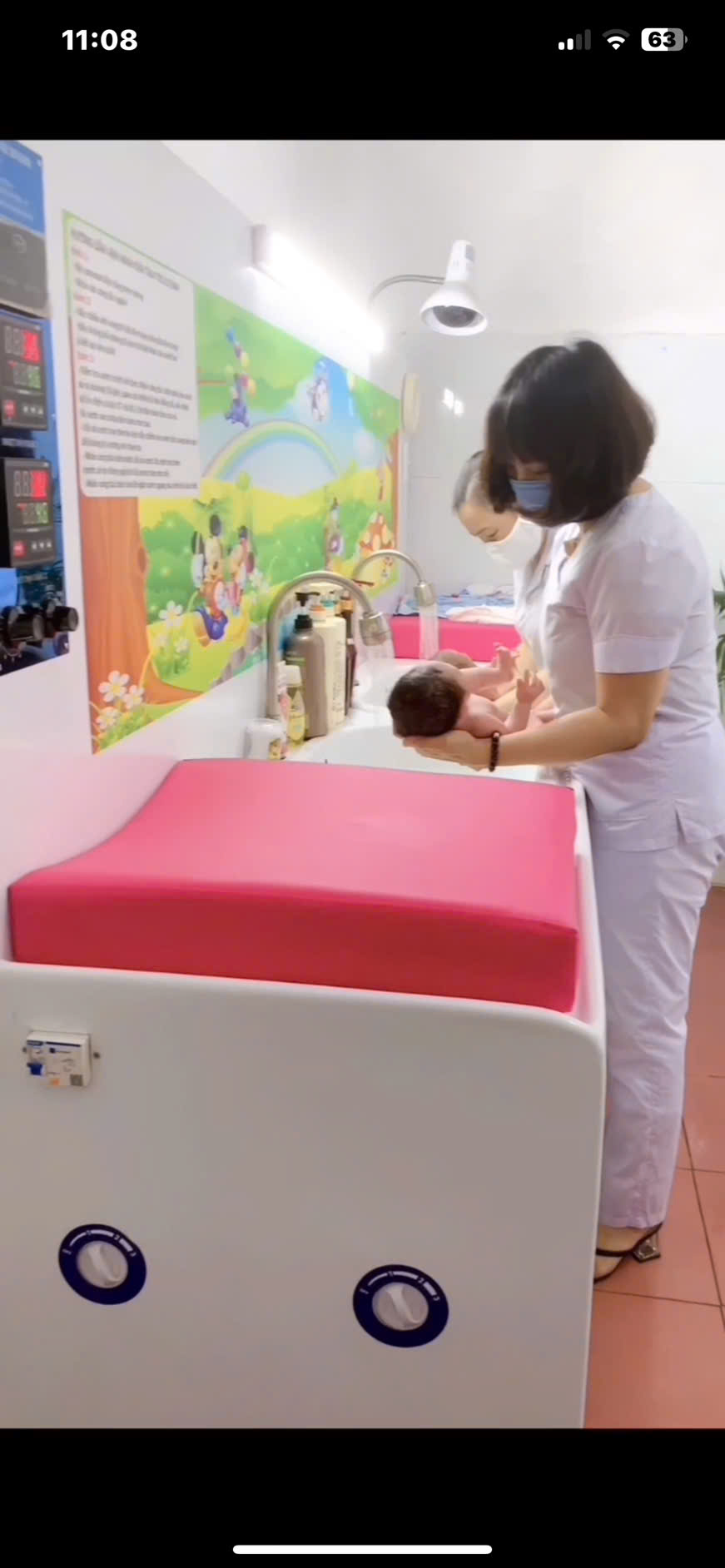 A person in a white uniform holding a baby
AI-generated content may be incorrect.