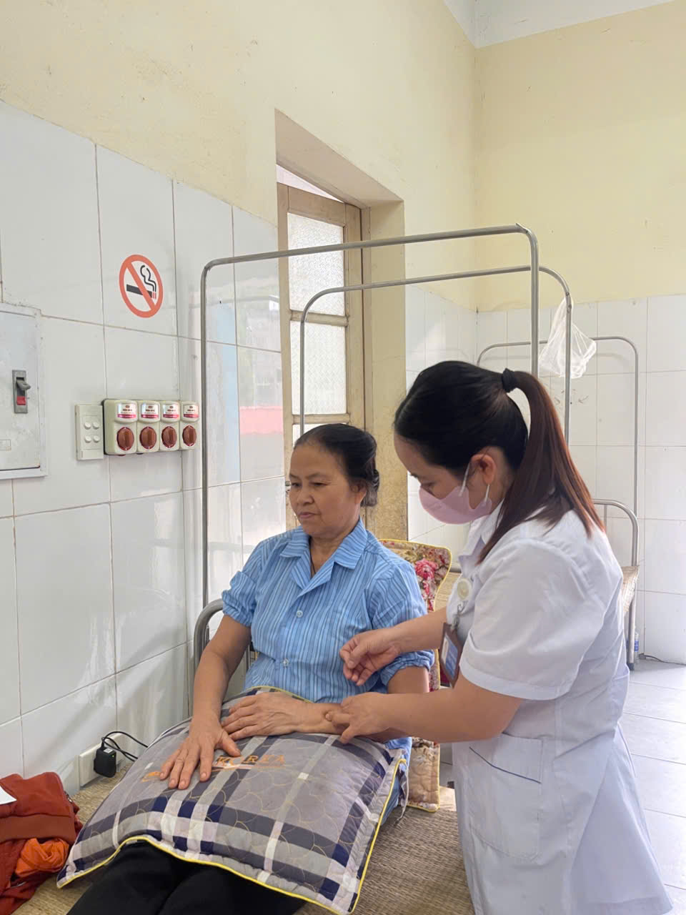 A nurse putting a blood pressure on a patient
AI-generated content may be incorrect.