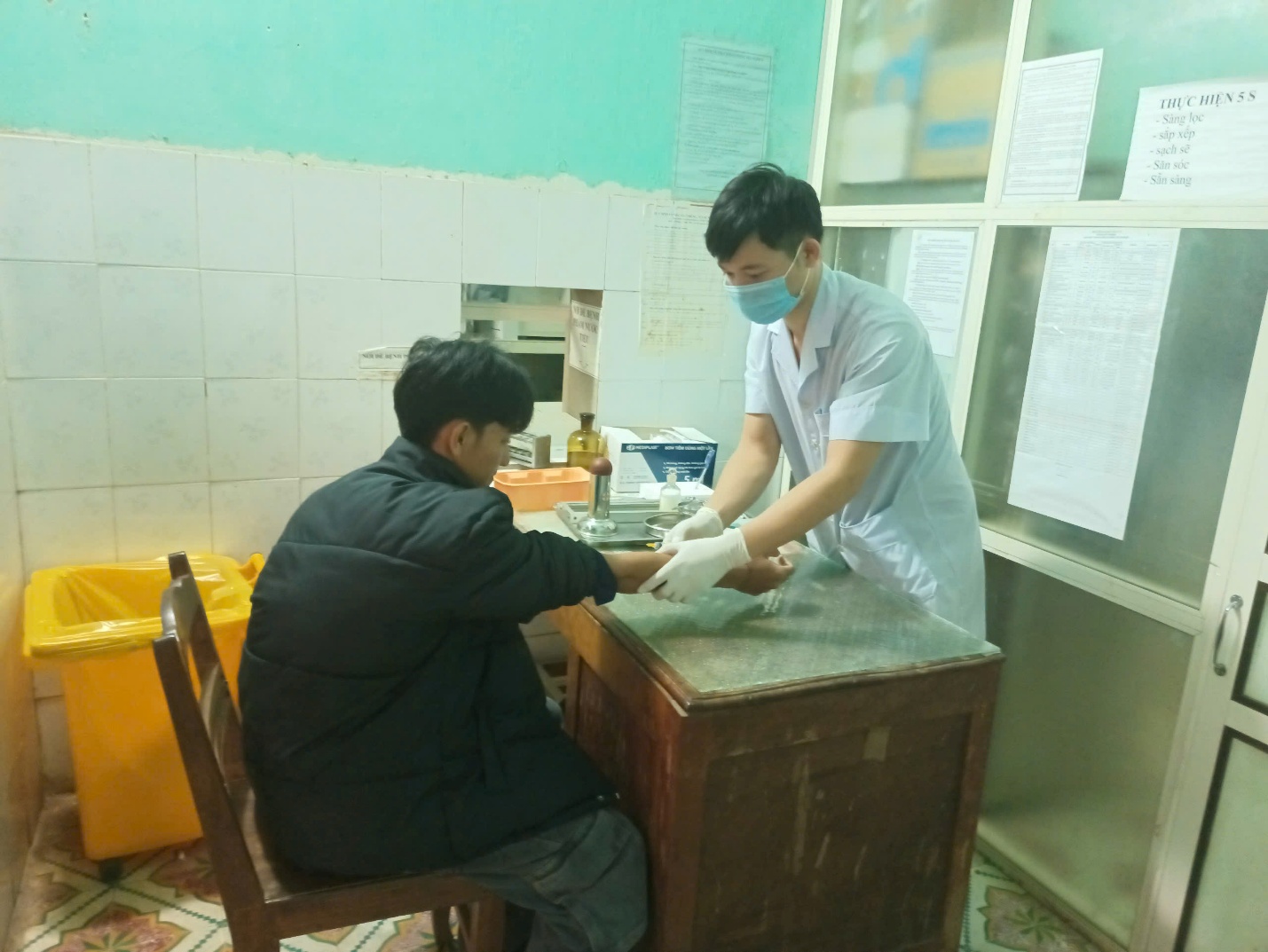 A person wearing a mask and gloves getting blood pressure
AI-generated content may be incorrect.