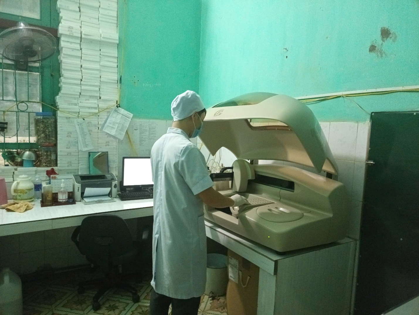 A person in a lab coat using a machine
AI-generated content may be incorrect.