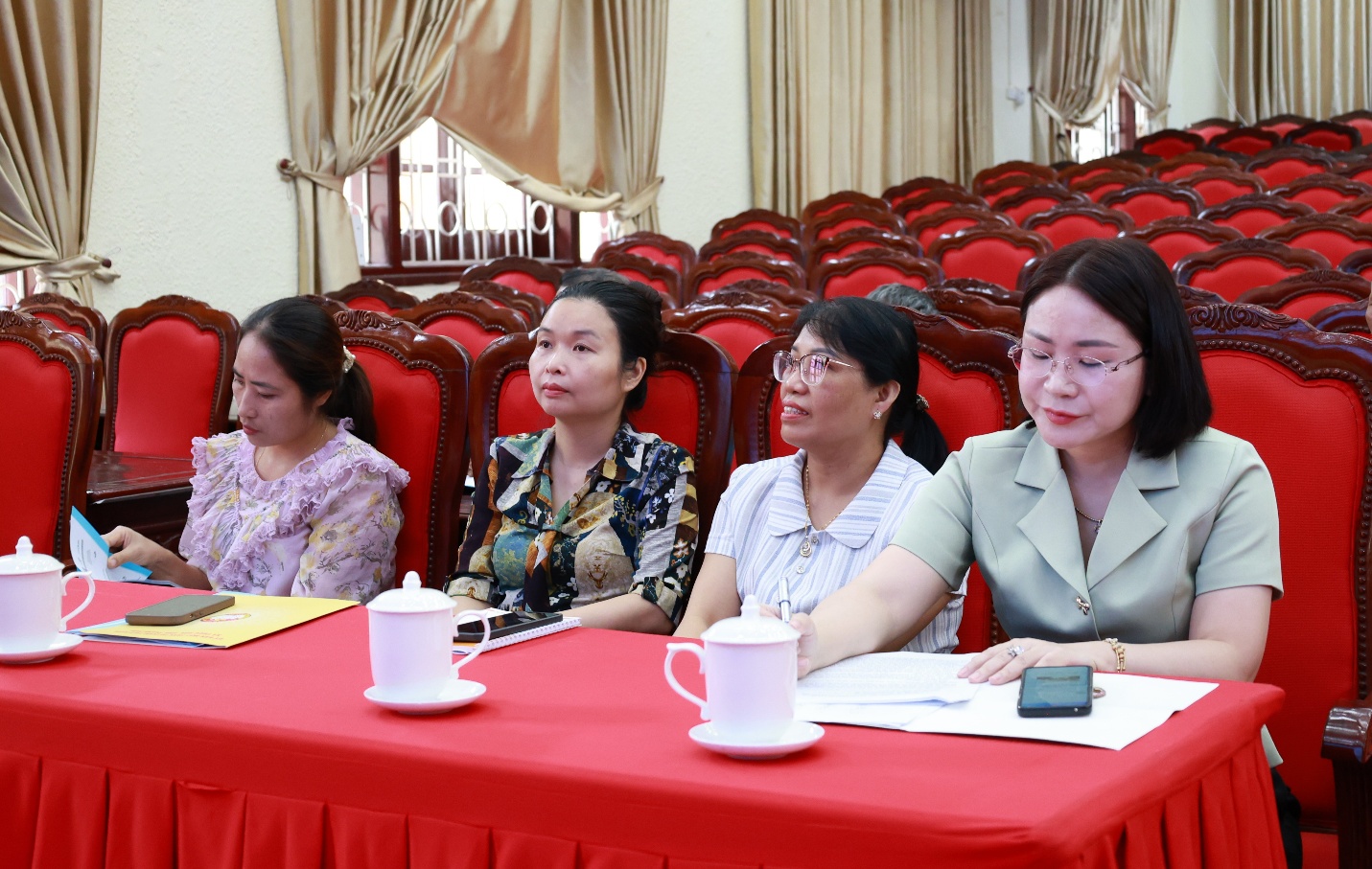 A group of women sitting at a table
Description automatically generated