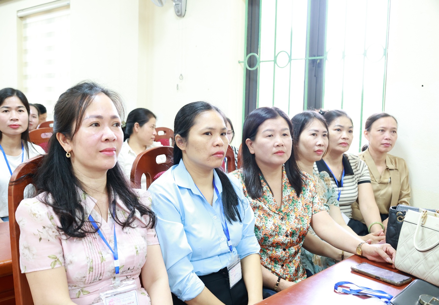A group of women sitting in a room
Description automatically generated