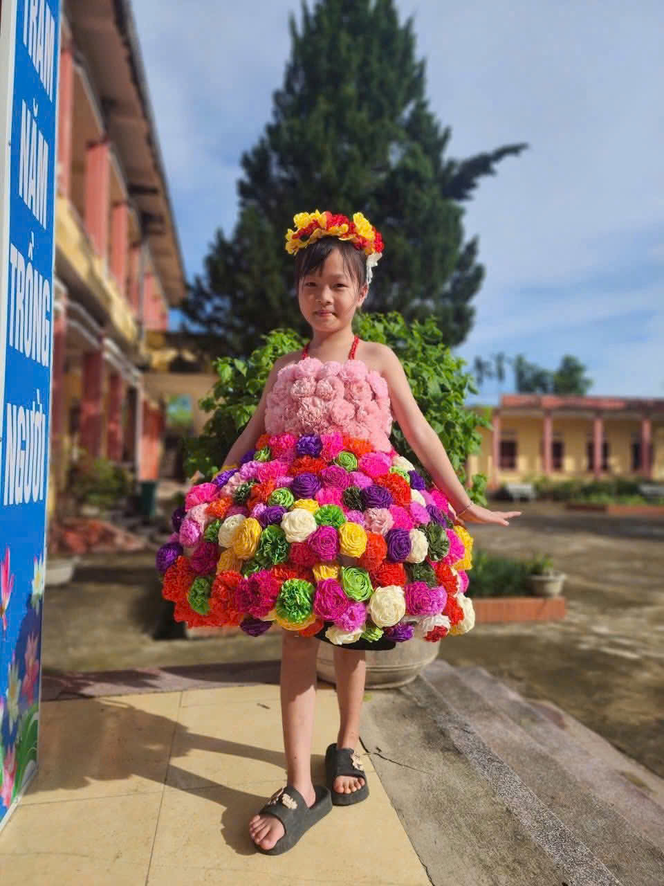 A child wearing a dress made of flowers
AI-generated content may be incorrect.