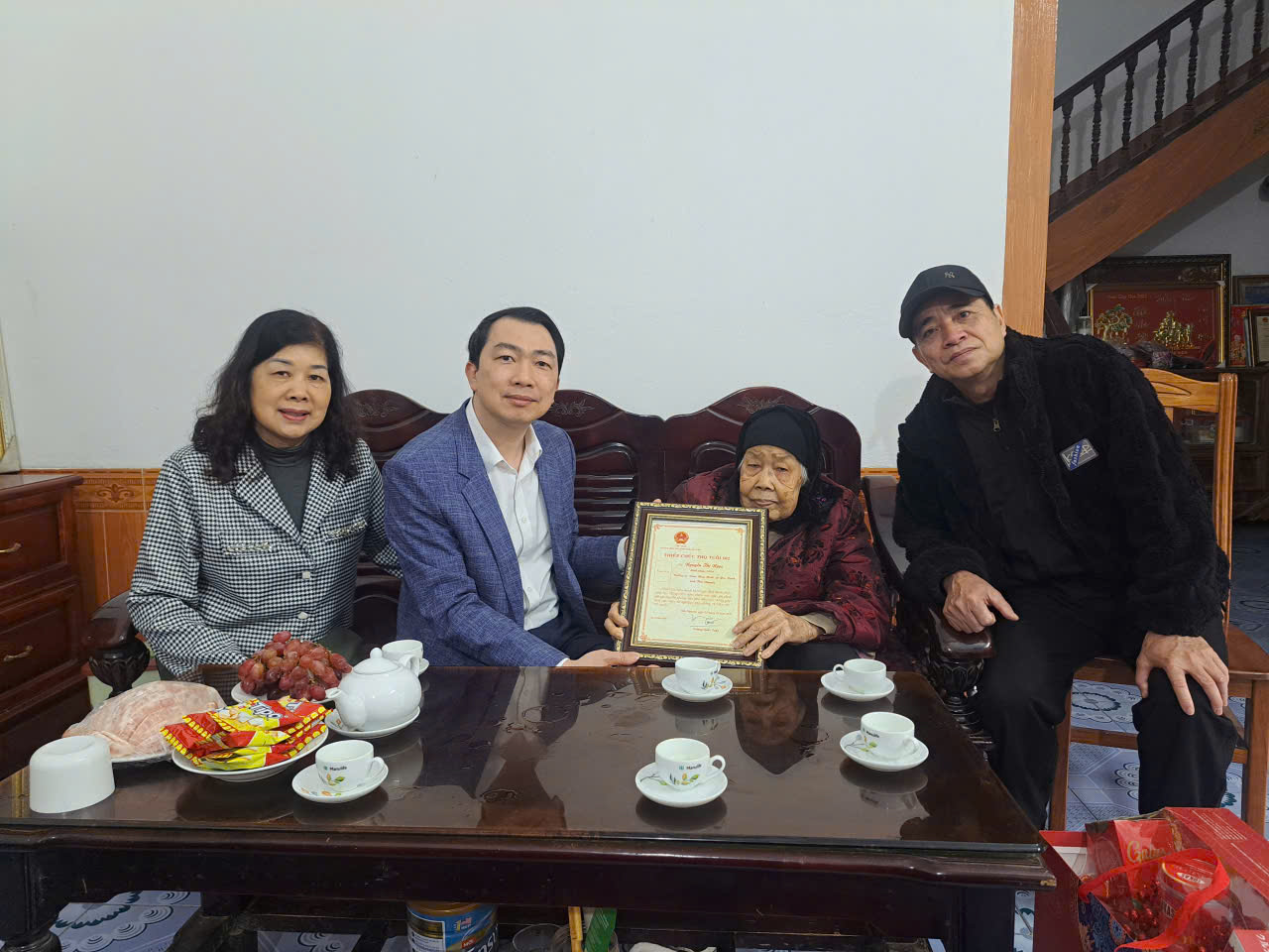 Đồng chí Phạm Trung Dũng, Phó Bí thư Thường trực Đảng ủy trao quà mừng thọ cho các cụ trên 100 tuổi trên địa bàn