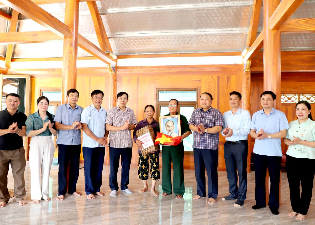 Chủ tịch UBND tỉnh Phan Huy Ngọc tặng cờ Tổ quốc, ảnh chân dung Chủ tịch Hồ Chí Minh và tặng quà hộ ông Nguyễn Viết Đôn, xã Đồng Yên.