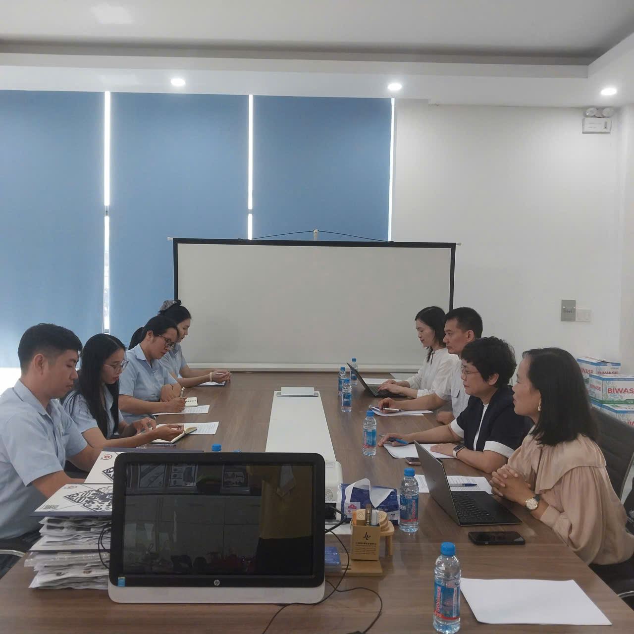 A group of people sitting around a table
Description automatically generated